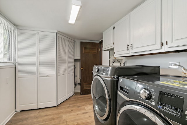 1083 Groton Ct, Schaumburg, IL 60193 - laundry area featuring cabinet space, washer and dryer, light wood-style floors, and baseboards