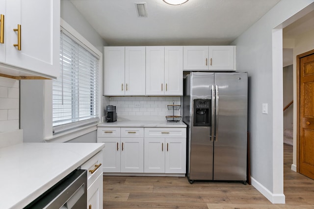 1083 Groton Ct, Schaumburg, IL 60193 - kitchen featuring stainless steel refrigerator with ice dispenser, white cabinets, light wood finished floors, backsplash, and baseboards