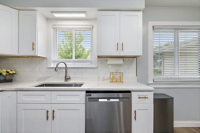1083 Groton Ct, Schaumburg, IL 60193 - kitchen featuring dishwasher, a sink, decorative backsplash, and white cabinetry