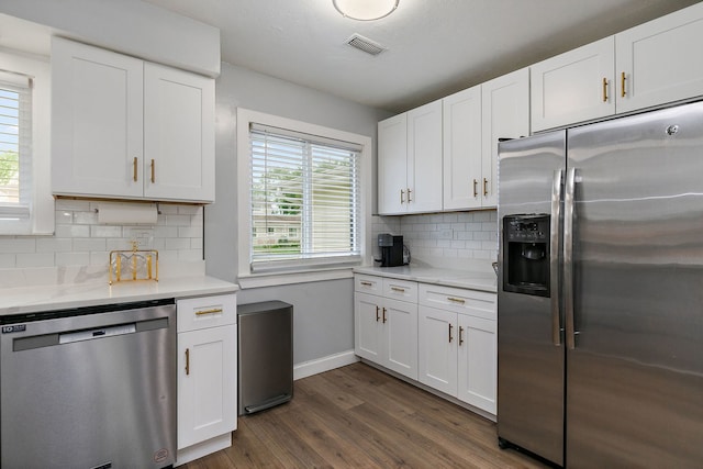 1083 Groton Ct, Schaumburg, IL 60193 - kitchen with appliances with stainless steel finishes, dark wood-style flooring, baseboards, and white cabinetry