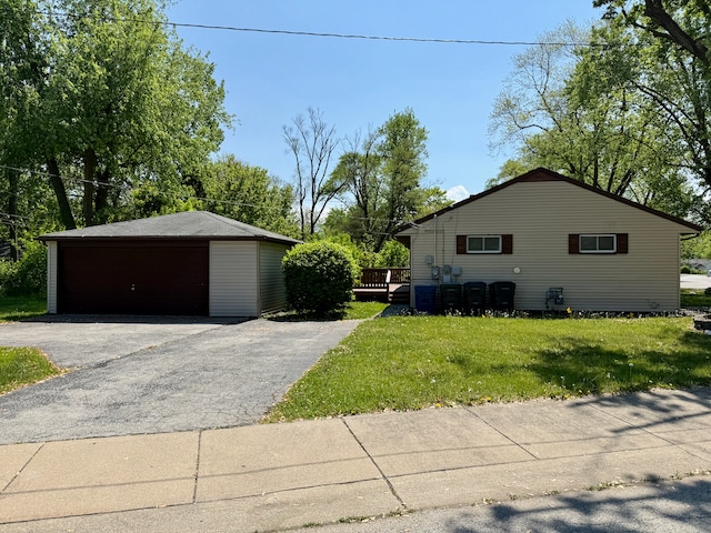15503 Park Ln, South Holland, IL 60473 - view of side of home with a detached garage, an outdoor structure, a yard, and a wooden deck