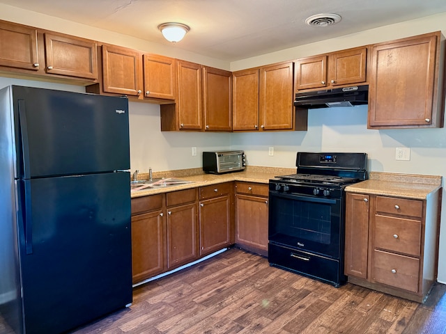 15503 Park Ln, South Holland, IL 60473 - kitchen with black appliances, under cabinet range hood, dark wood-style flooring, and light countertops