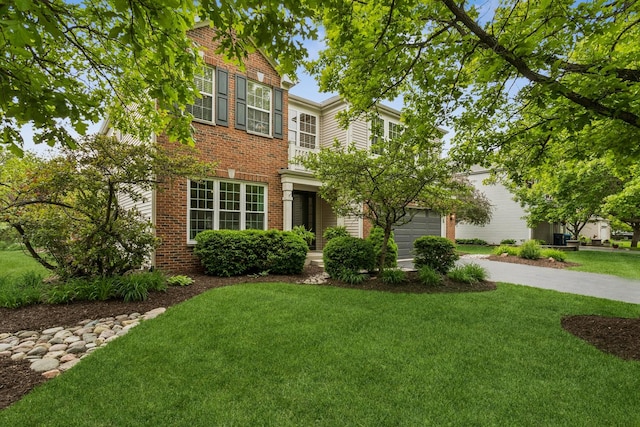 727 Sumac Dr, Aurora, IL 60506 - view of front of home with brick siding, driveway, and a front yard
