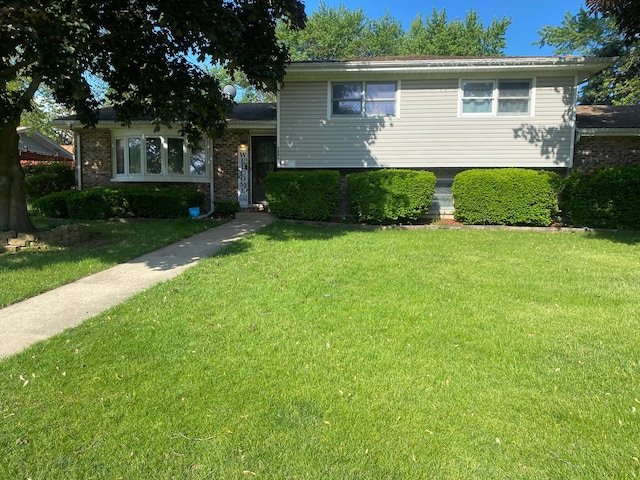 1161 Comet Dr, Aurora, IL 60505 - tri-level home featuring a front lawn and brick siding