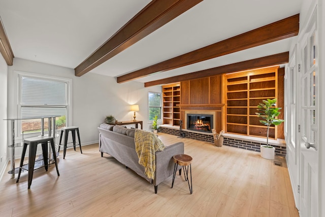 2S644 Devonshire Ln, Glen Ellyn, IL 60137 - living area with light wood-style flooring, beam ceiling, baseboards, a brick fireplace, and built in features