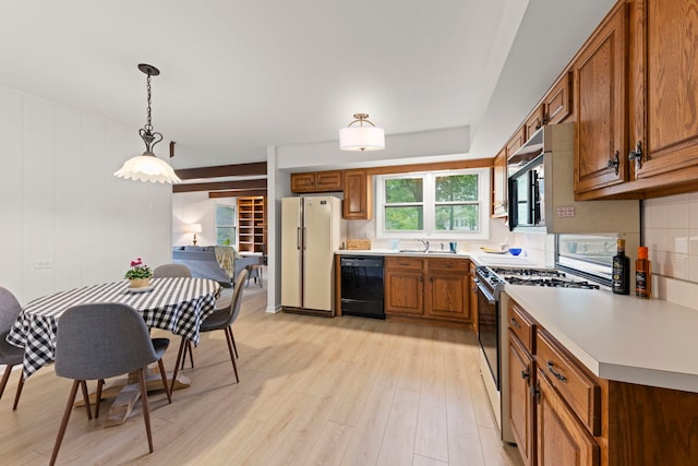 2S644 Devonshire Ln, Glen Ellyn, IL 60137 - kitchen featuring black dishwasher, freestanding refrigerator, range with gas cooktop, brown cabinets, and light wood-style floors