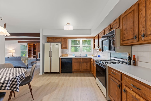 2S644 Devonshire Ln, Glen Ellyn, IL 60137 - kitchen with black appliances, a sink, brown cabinetry, light countertops, and decorative backsplash
