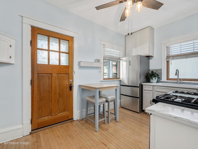 11 S Catherine Ave, La Grange, IL 60525 - kitchen featuring freestanding refrigerator, white cabinetry, a sink, and ceiling fan