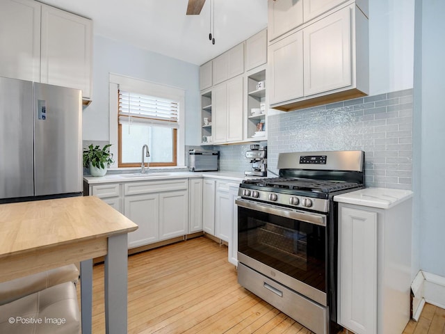 11 S Catherine Ave, La Grange, IL 60525 - kitchen with stainless steel appliances, a sink, open shelves, tasteful backsplash, and light wood-style flooring