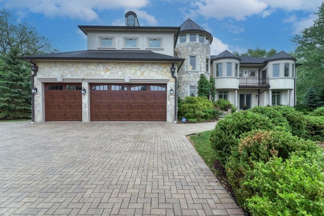 22W305 Broker Rd, Medinah, IL 60157 - view of front of house with decorative driveway, stone siding, a garage, and stucco siding