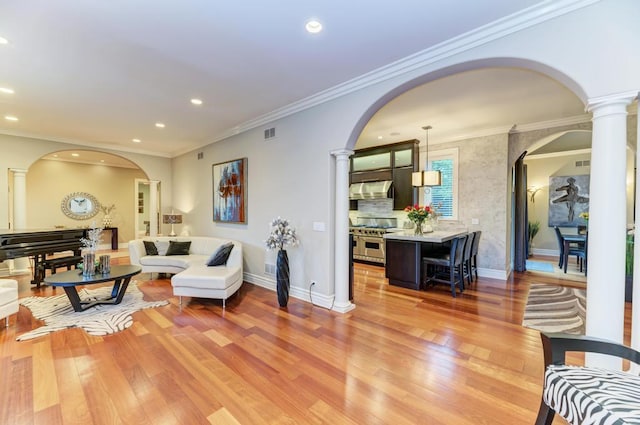 22W305 Broker Rd, Medinah, IL 60157 - living area with decorative columns, arched walkways, recessed lighting, light wood finished floors, and ornamental molding