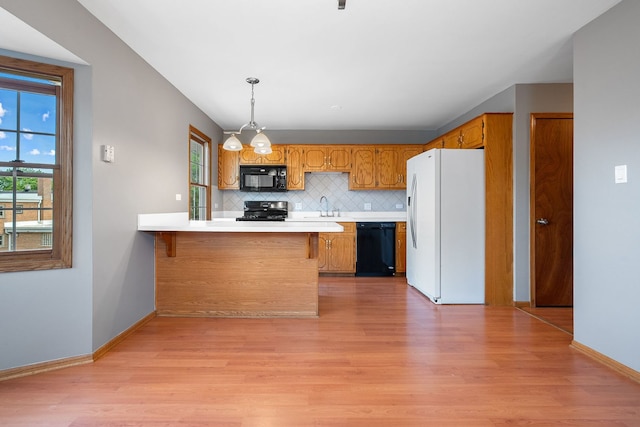 5343 S Long Ave Unit 5, Chicago, IL 60638 - kitchen with black appliances, light wood-style floors, a peninsula, and a sink