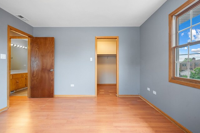5343 S Long Ave Unit 5, Chicago, IL 60638 - unfurnished bedroom with light wood finished floors, baseboards, and a walk in closet