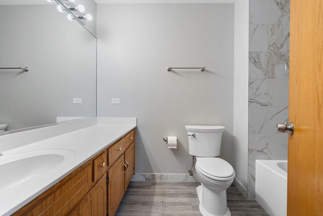 5343 S Long Ave Unit 5, Chicago, IL 60638 - bathroom featuring toilet, vanity, baseboards, and wood finished floors