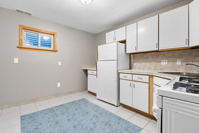 5343 S Long Ave Unit 5, Chicago, IL 60638 - kitchen featuring white appliances, light countertops, white cabinetry, and backsplash