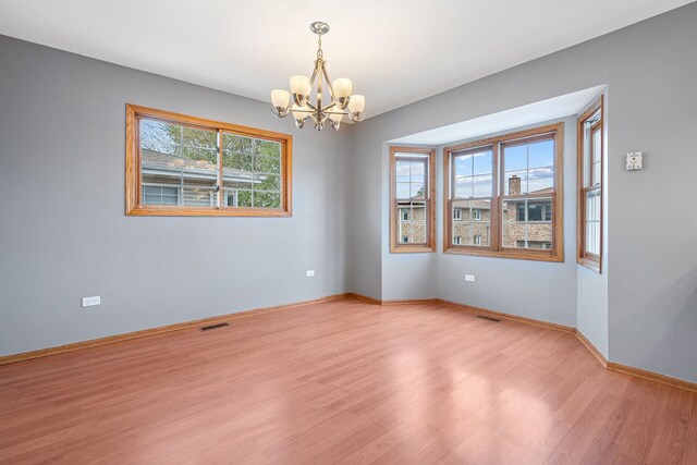 5343 S Long Ave Unit 5, Chicago, IL 60638 - spare room featuring a chandelier, light wood-type flooring, and baseboards