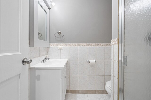 5343 S Long Ave Unit 5, Chicago, IL 60638 - bathroom featuring vanity, toilet, a shower stall, tile walls, and tile patterned floors