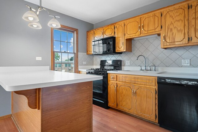 5343 S Long Ave Unit 5, Chicago, IL 60638 - kitchen with black appliances, a sink, light countertops, and light wood-style flooring
