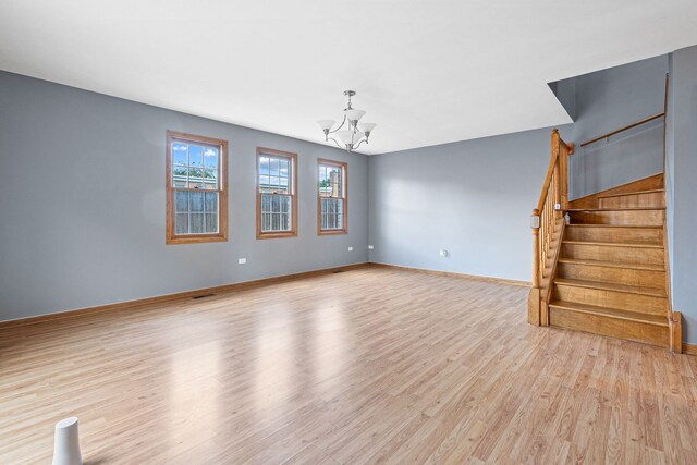 5343 S Long Ave Unit 5, Chicago, IL 60638 - unfurnished living room with light wood-style floors, a chandelier, stairs, and baseboards