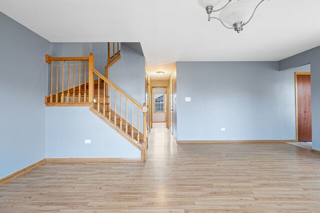 5343 S Long Ave Unit 5, Chicago, IL 60638 - unfurnished living room with wood finished floors, stairs, and baseboards