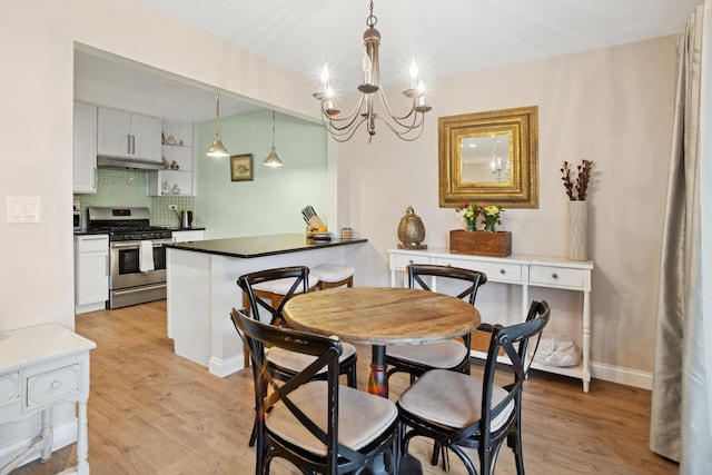 54 Brookston Dr Unit A1, Schaumburg, IL 60193 - dining area with a chandelier, light wood finished floors, and baseboards