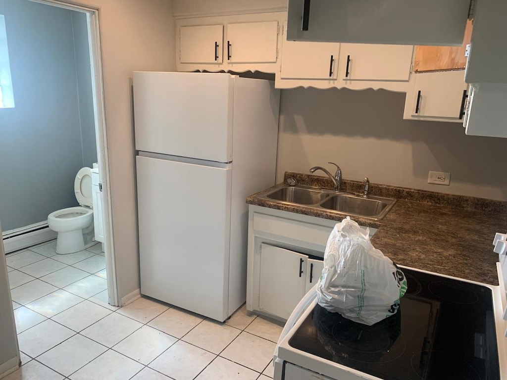 3119 Scoville Ave Unit 7, Berwyn, IL 60402 - kitchen featuring white appliances, a sink, a baseboard heating unit, white cabinetry, and dark countertops