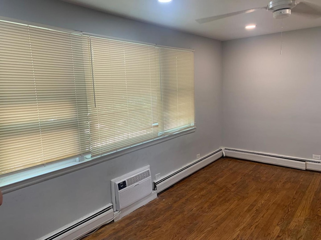 3119 Scoville Ave Unit 7, Berwyn, IL 60402 - unfurnished room featuring baseboard heating, ceiling fan, a wall mounted air conditioner, wood finished floors, and recessed lighting