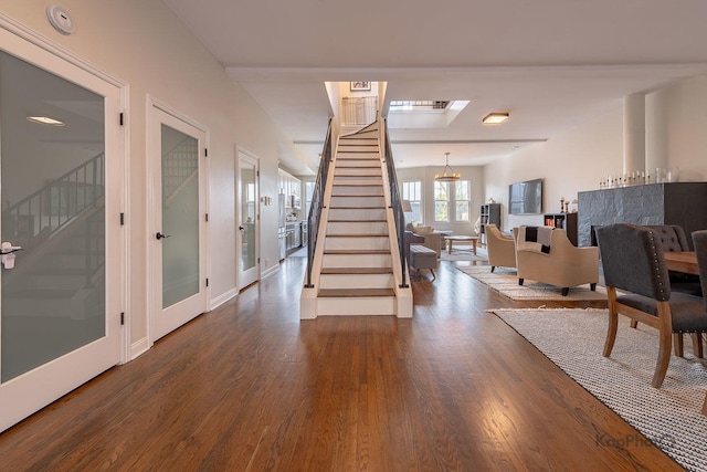 2044 W Roscoe St Unit 2S, Chicago, IL 60618 - foyer entrance with stairway, wood finished floors, and baseboards
