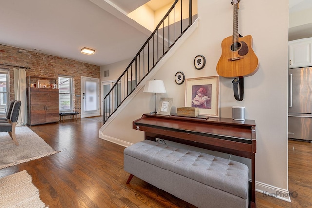 2044 W Roscoe St Unit 2S, Chicago, IL 60618 - staircase featuring brick wall, wood finished floors, and baseboards
