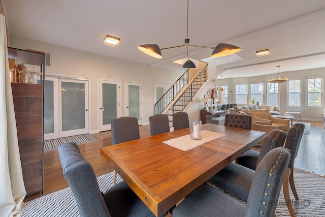 2044 W Roscoe St Unit 2S, Chicago, IL 60618 - dining space featuring stairs, wood finished floors, baseboards, and a chandelier