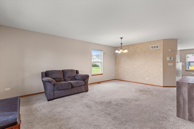 1129 S Wabena Ave, Minooka, IL 60447 - unfurnished living room featuring a chandelier, carpet floors, and baseboards