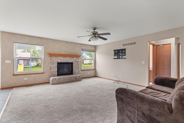 1129 S Wabena Ave, Minooka, IL 60447 - living area with baseboards, a ceiling fan, carpet flooring, and a fireplace