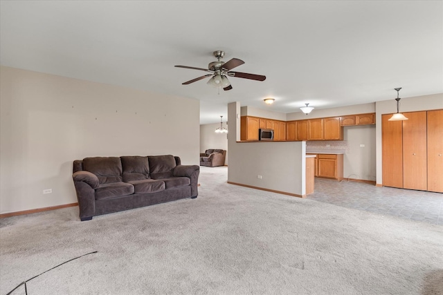 1129 S Wabena Ave, Minooka, IL 60447 - living room with light carpet, baseboards, and a ceiling fan