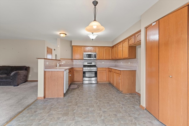 1129 S Wabena Ave, Minooka, IL 60447 - kitchen with appliances with stainless steel finishes, open floor plan, a sink, backsplash, and light countertops
