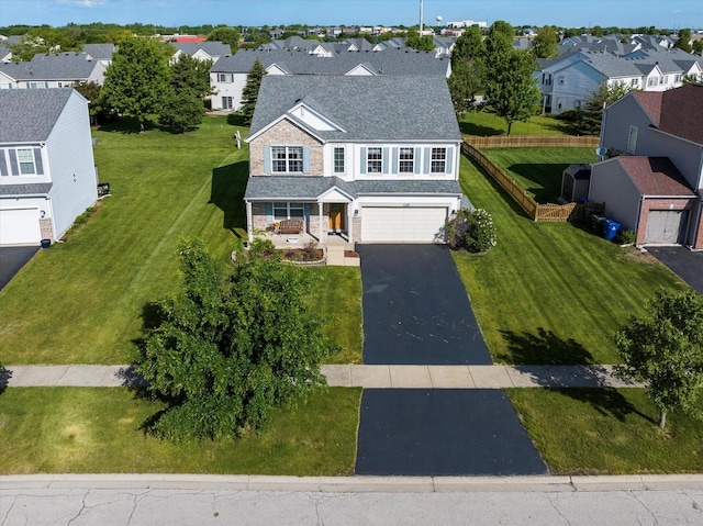 1129 S Wabena Ave, Minooka, IL 60447 - view of front facade featuring driveway, a residential view, roof with shingles, and an attached garage