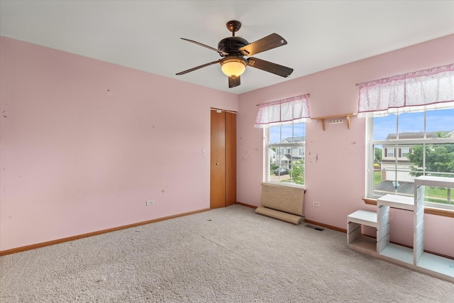 1129 S Wabena Ave, Minooka, IL 60447 - carpeted spare room with baseboards and a ceiling fan