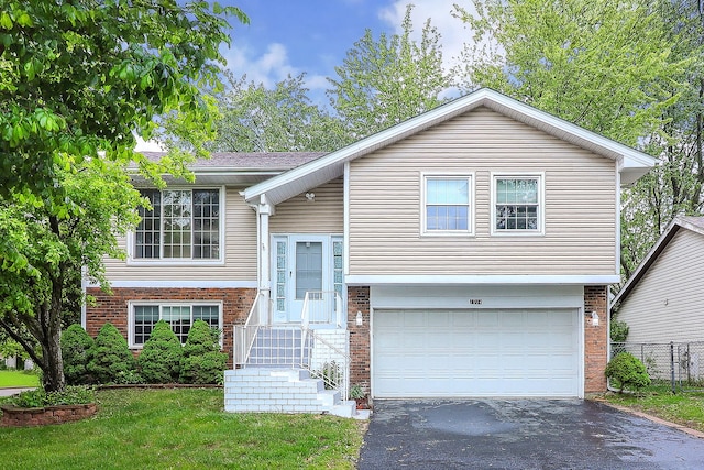 1914 Brookside Ln, Hoffman Estates, IL 60169 - raised ranch featuring brick siding, an attached garage, and driveway