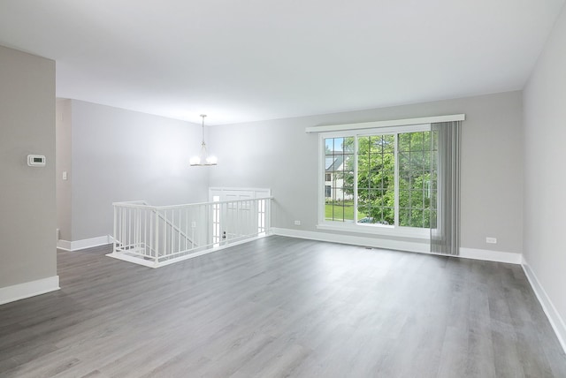 1914 Brookside Ln, Hoffman Estates, IL 60169 - unfurnished room featuring wood finished floors, a chandelier, and baseboards