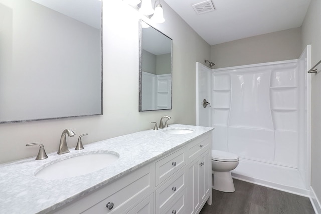 1914 Brookside Ln, Hoffman Estates, IL 60169 - full bathroom featuring a shower, wood finished floors, toilet, and double vanity