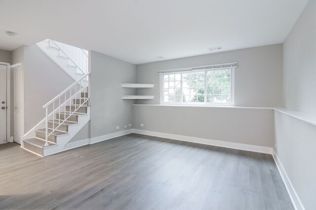 1914 Brookside Ln, Hoffman Estates, IL 60169 - spare room with stairway, wood finished floors, and baseboards