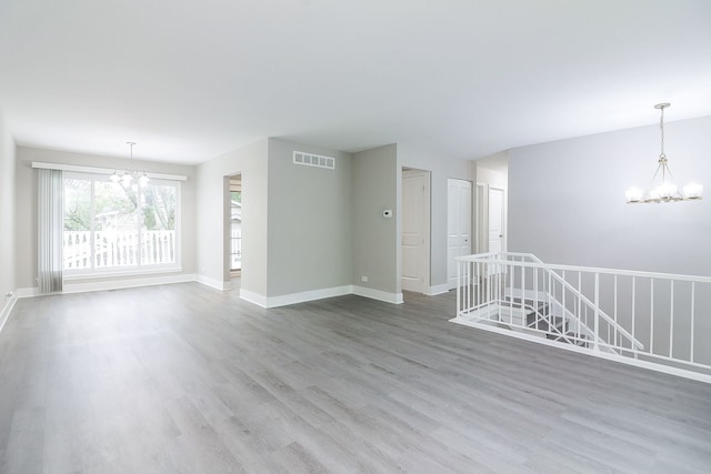 1914 Brookside Ln, Hoffman Estates, IL 60169 - unfurnished room featuring a chandelier, wood finished floors, and baseboards