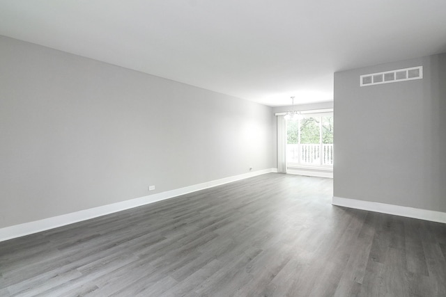 1914 Brookside Ln, Hoffman Estates, IL 60169 - unfurnished room featuring dark wood-style floors, baseboards, and a chandelier