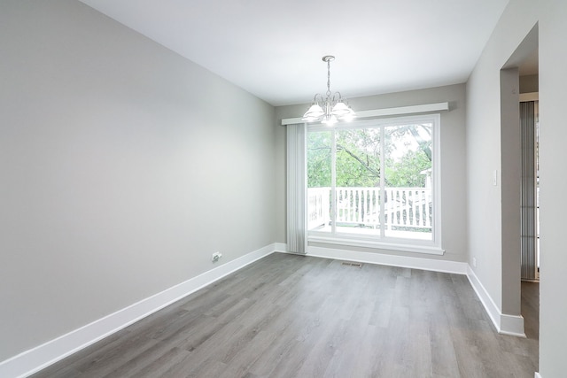 1914 Brookside Ln, Hoffman Estates, IL 60169 - unfurnished dining area featuring wood finished floors, baseboards, and a chandelier