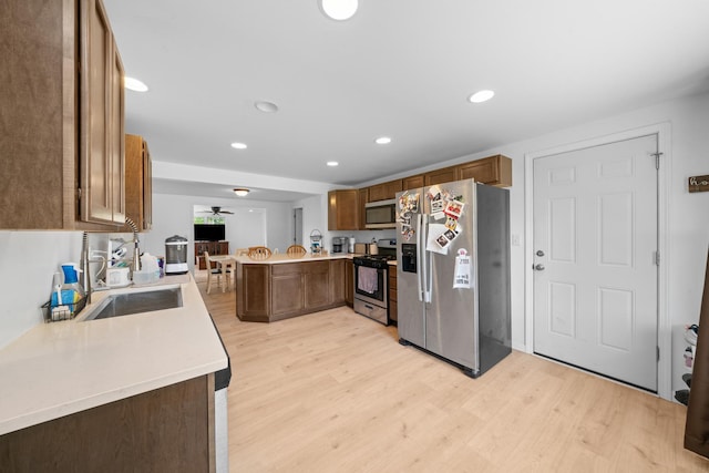 341 Cardinal Ln, Lake Holiday, IL 60552 - kitchen with appliances with stainless steel finishes, a peninsula, light wood-style flooring, a sink, and recessed lighting