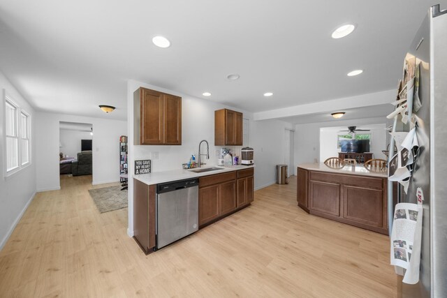 341 Cardinal Ln, Lake Holiday, IL 60552 - kitchen with dishwasher, a sink, light wood-type flooring, light countertops, and baseboards