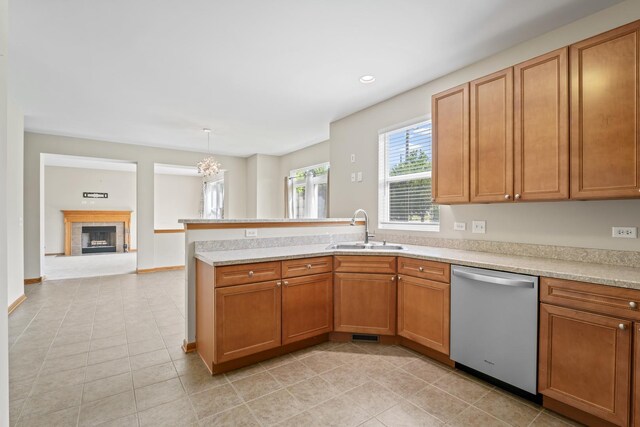 3816 Stockton Dr, Joliet, IL 60436 - kitchen featuring dishwasher, a sink, light countertops, a peninsula, and light tile patterned floors