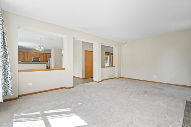 3816 Stockton Dr, Joliet, IL 60436 - carpeted spare room featuring a chandelier and baseboards