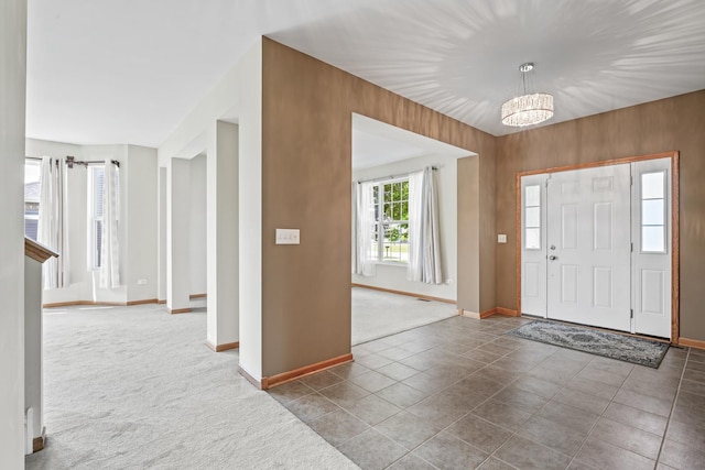 3816 Stockton Dr, Joliet, IL 60436 - carpeted foyer with baseboards, a chandelier, and tile patterned flooring