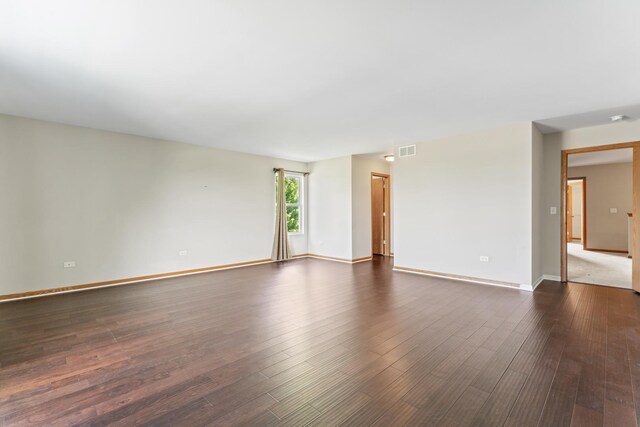 3816 Stockton Dr, Joliet, IL 60436 - spare room featuring dark wood-type flooring and baseboards