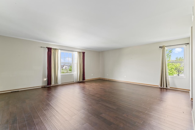 3816 Stockton Dr, Joliet, IL 60436 - empty room with plenty of natural light, dark wood-style flooring, and baseboards